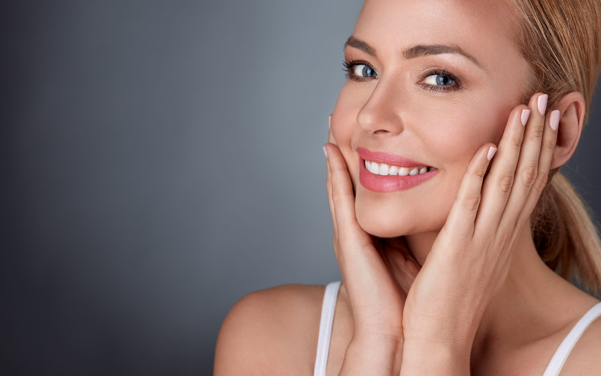 A woman smiling after Revanesse® Versa in Melville, NY